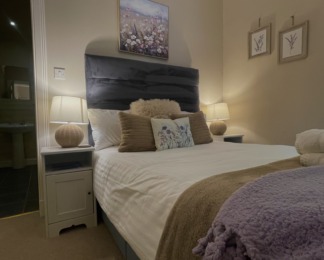 room 3's bed looking cosy with lamps lit