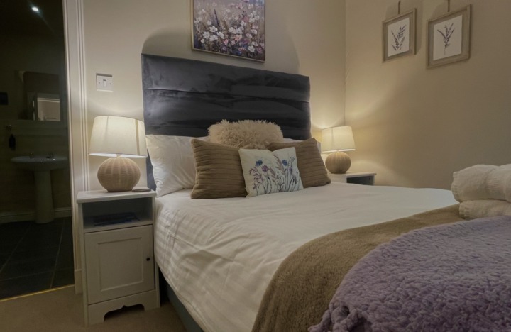 room 3's bed looking cosy with lamps lit